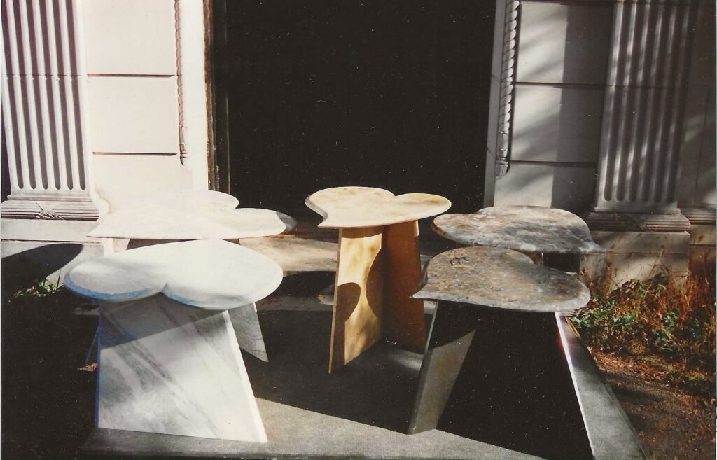 Group of heart-shaped stone tables by Bruce Bennett in several varieties of marble and stone, photographed outside Candoro Marble.