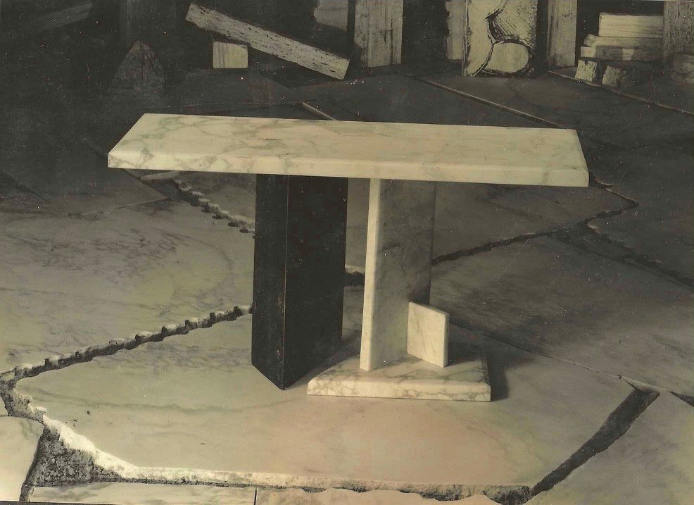 Marble table by Bruce Bennett with an asymmetrical top and geometric marble base.
