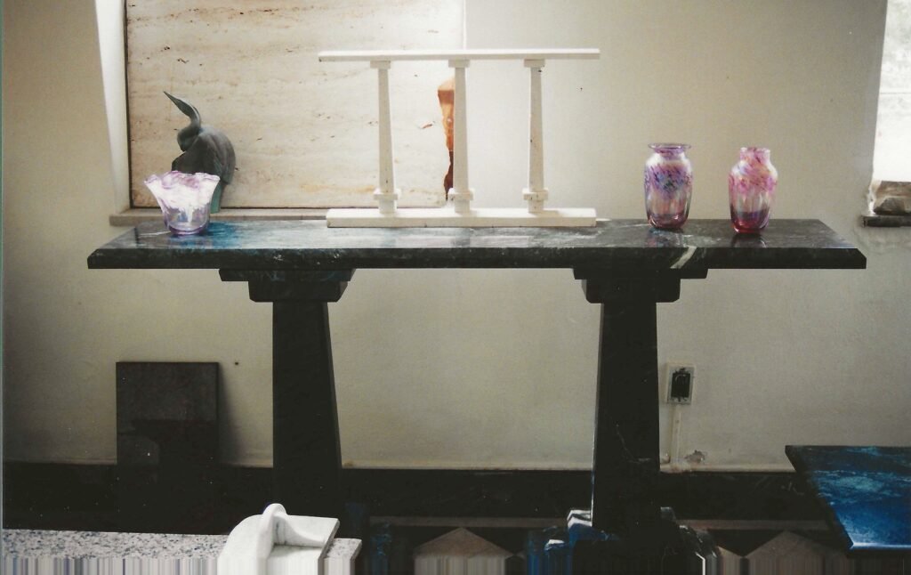 Black marble table bu Bruce Bennett displaying handblown glass by Connie Christopher.