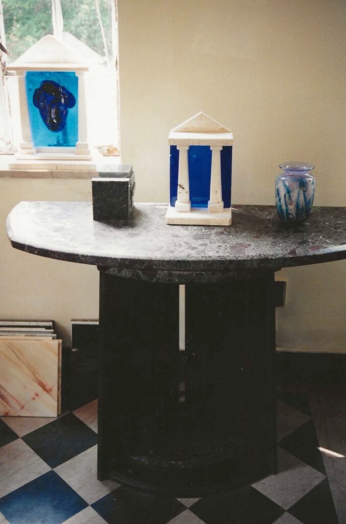 Bianco Romano granite table by Bruce Bennett, shown with several of his small temple sculptures.