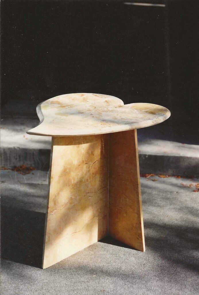 Heart-shaped Calacatta Umber marble side table by Bruce Bennett with a geometric intersecting slab base.