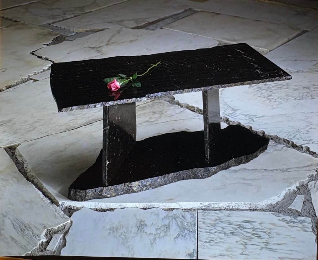 Bruce Bennett sculptural table in Via Lattea granite with polished surfaces and contrasting natural stone edges.