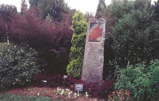 Allen Cox’s Eruption, a tall stone sculpture featuring an enamel-painted volcanic eruption, created for the 2003 One-Ton Show.
