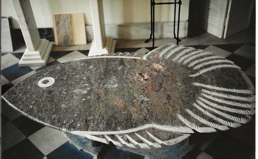 Bruce Bennett fish-shaped granite table with intricately carved fins, tail, and contrasting stone eye.