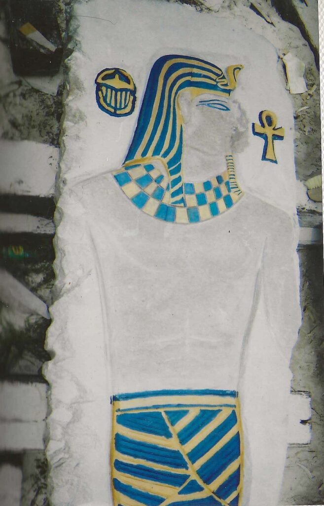 Donald Riggs’s Glory Days, an Egyptian-themed stone stele with low-relief carvings highlighted in bright blue and yellow enamel on Tennessee marble.