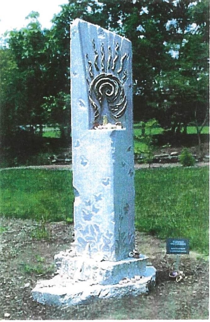 Mona Shiber de Kay’s Peace Is Every Breath, a carved Tennessee marble stele with a candle niche and symbolic imagery, created for the 2003 One-Ton Symposium.