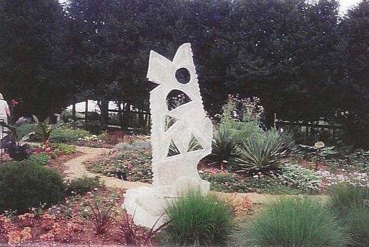 Alan Finch’s Ruder Forms Survive, an abstract Tennessee marble sculpture with geometric openings, created for the 2003 One-Ton Symposium.