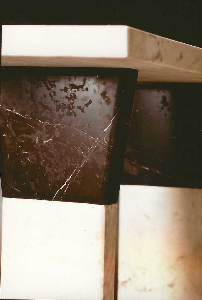 Artist detail showing contrasting white and black marble in the legs of Bruce Bennett’s high-top table.