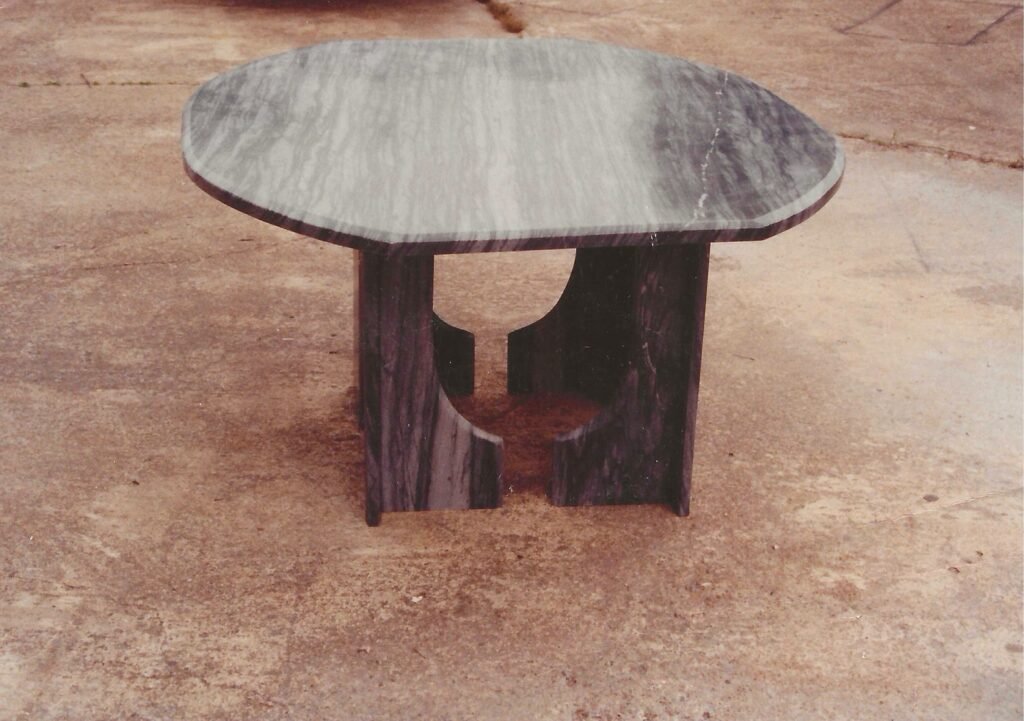 Bruce Bennett table in gray Bardiglio marble with a sculptural curved base.