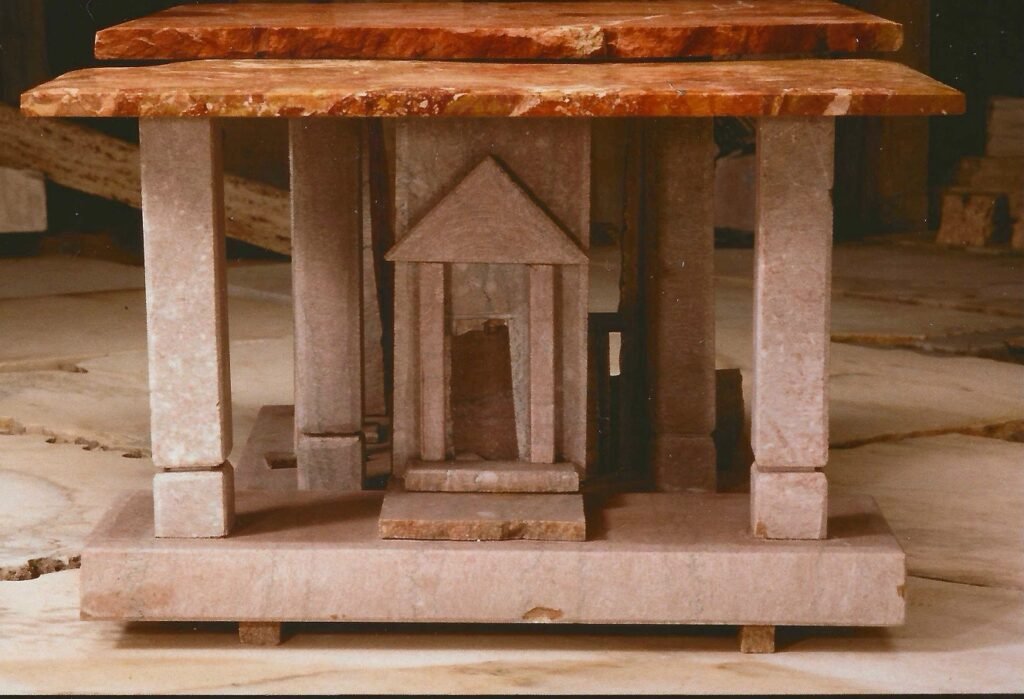 Bruce Bennett table with Rosso marble top and limestone base, featuring one of Bennett’s carved stone temples.