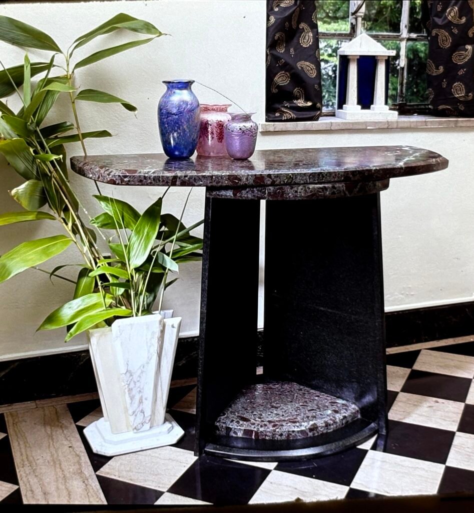Bruce Bennett high-top table with granite top and matching granite foot accent.