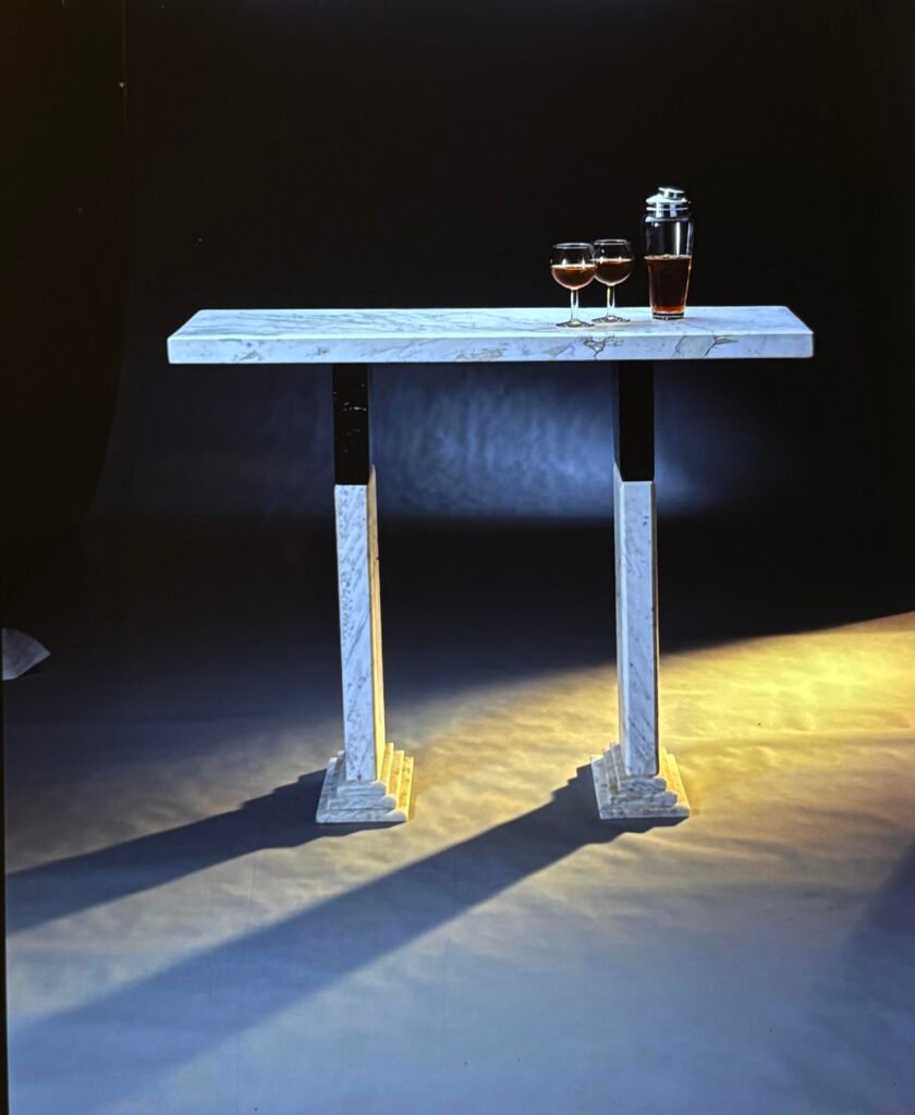 High-top table by Bruce Bennett with a white marble top and legs accented with black marble.